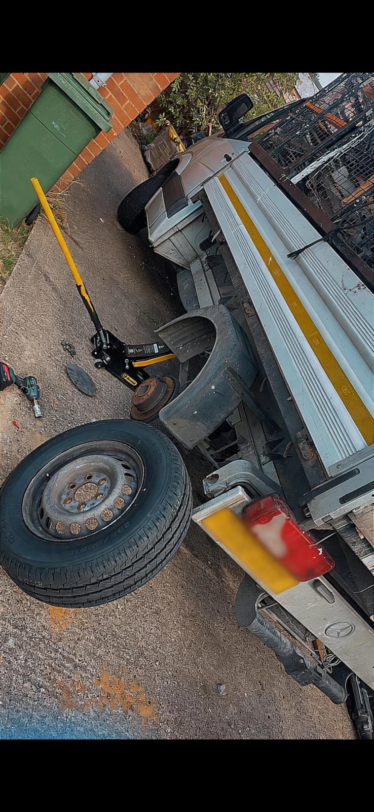 Commercial tipper truck with the wheel removed exposing the brake disc and hub during a mobile tyre replacement in Aylesbury